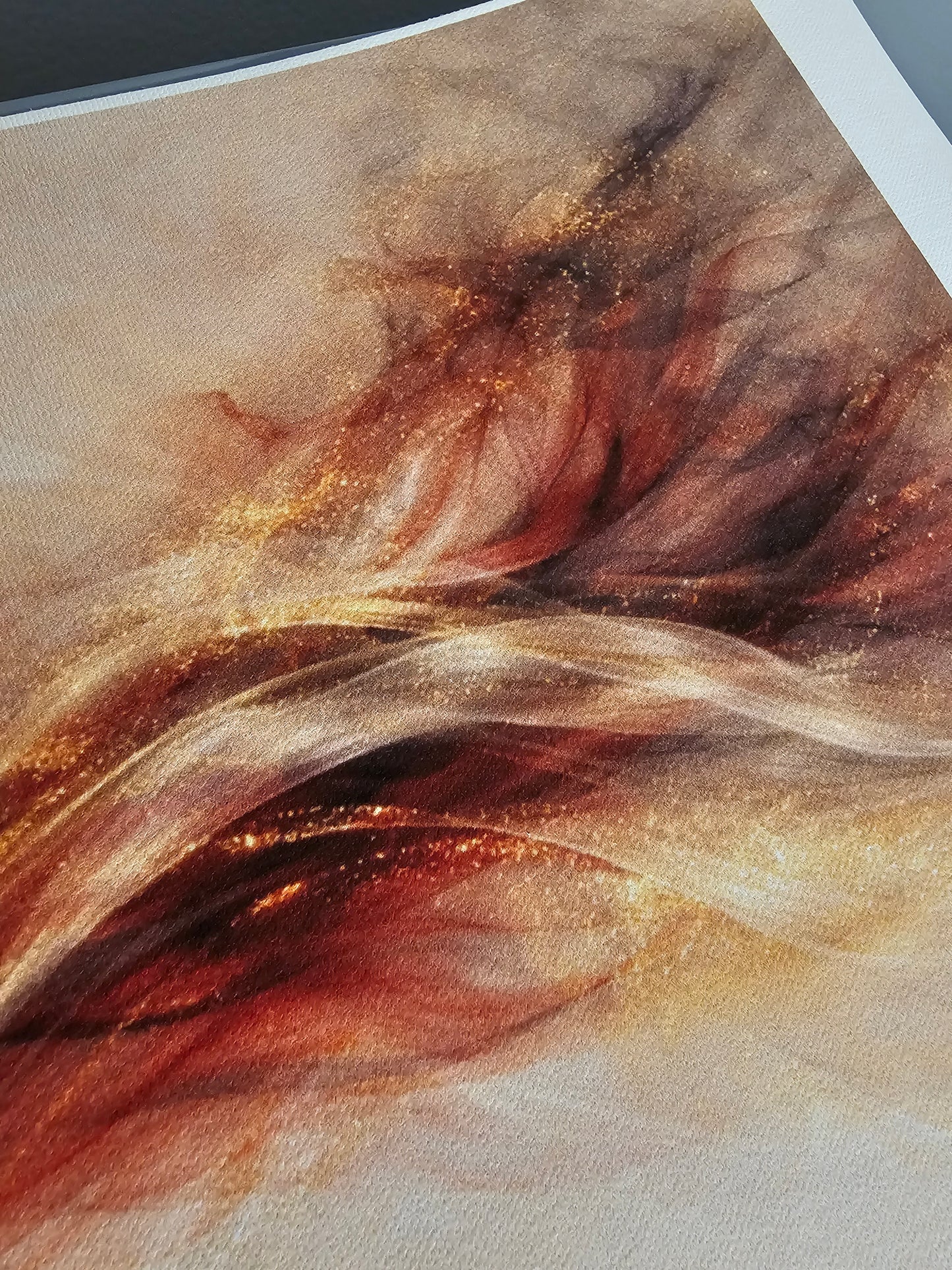 Abstract art with swirling brown, red and beige colors on a textured surface