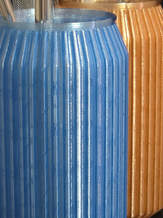 Close-up of a blue metal gear meshing with a gold metal gear.