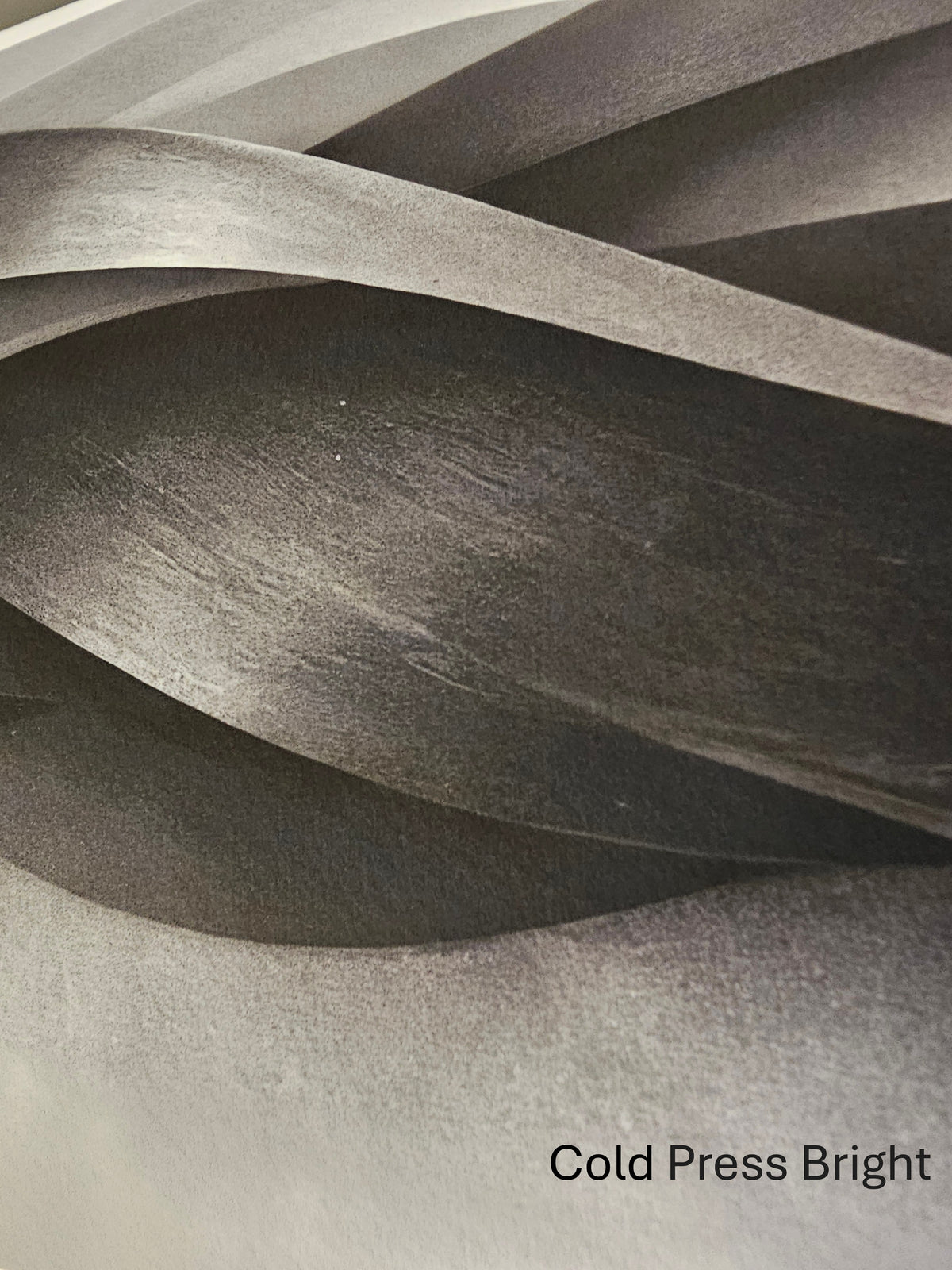 Textured paper with wavy layers and 'Cold Press Bright' label
