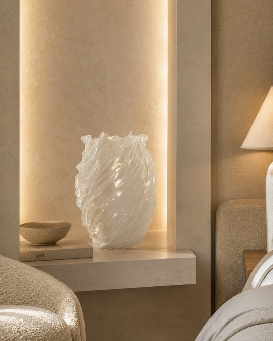 Decorative vase on a shelf in a softly lit room