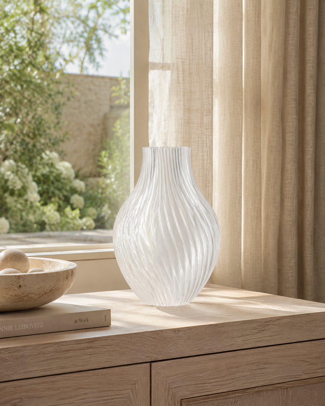 White textured vase on a wooden surface with a window and curtains in the background