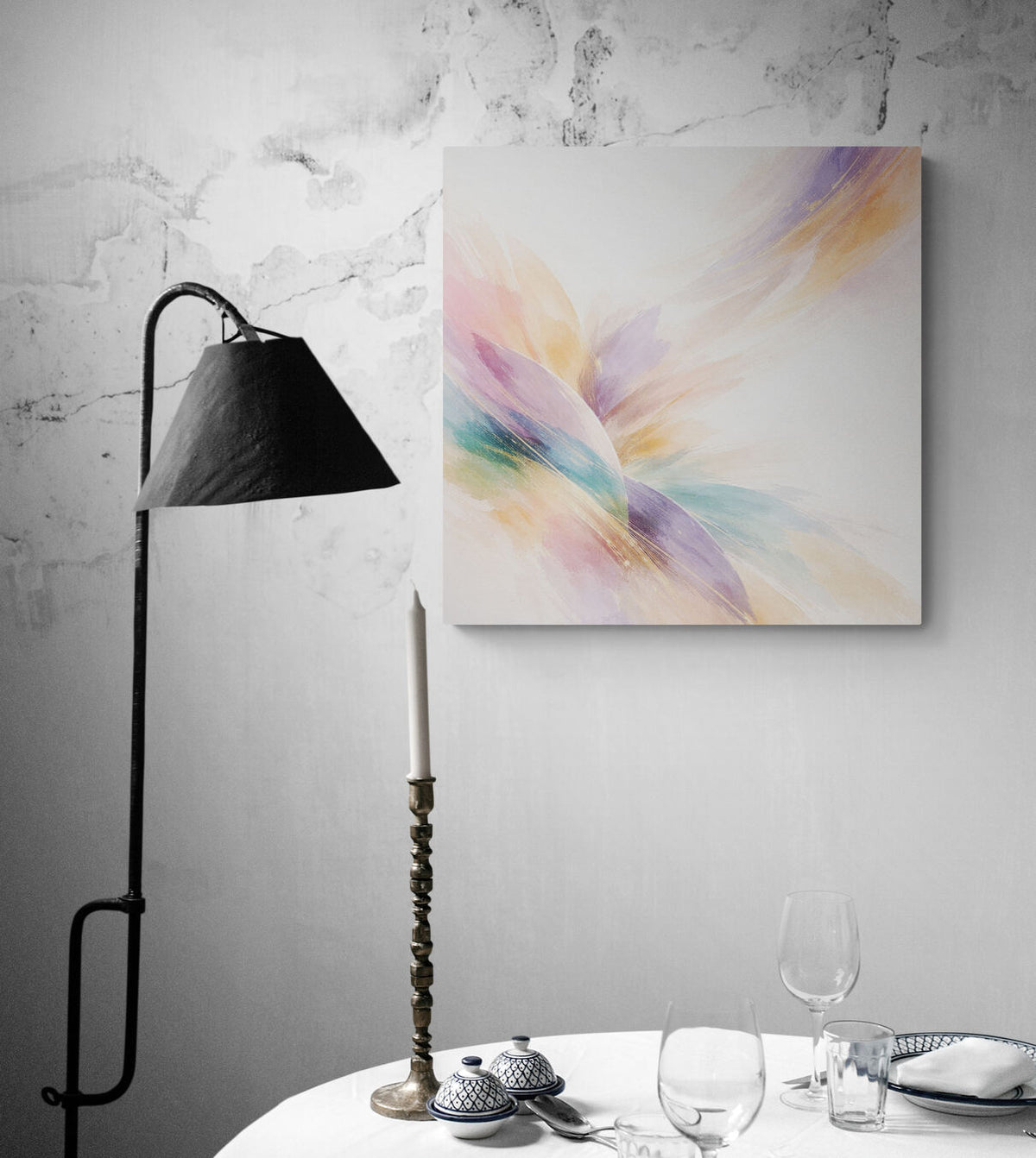 Colorful abstract painting on a gray wall with a lamp and table setting below.
