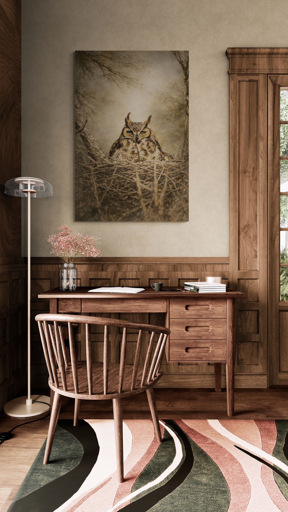 Wooden desk with chair in a room with a painting of an owl on the wall.