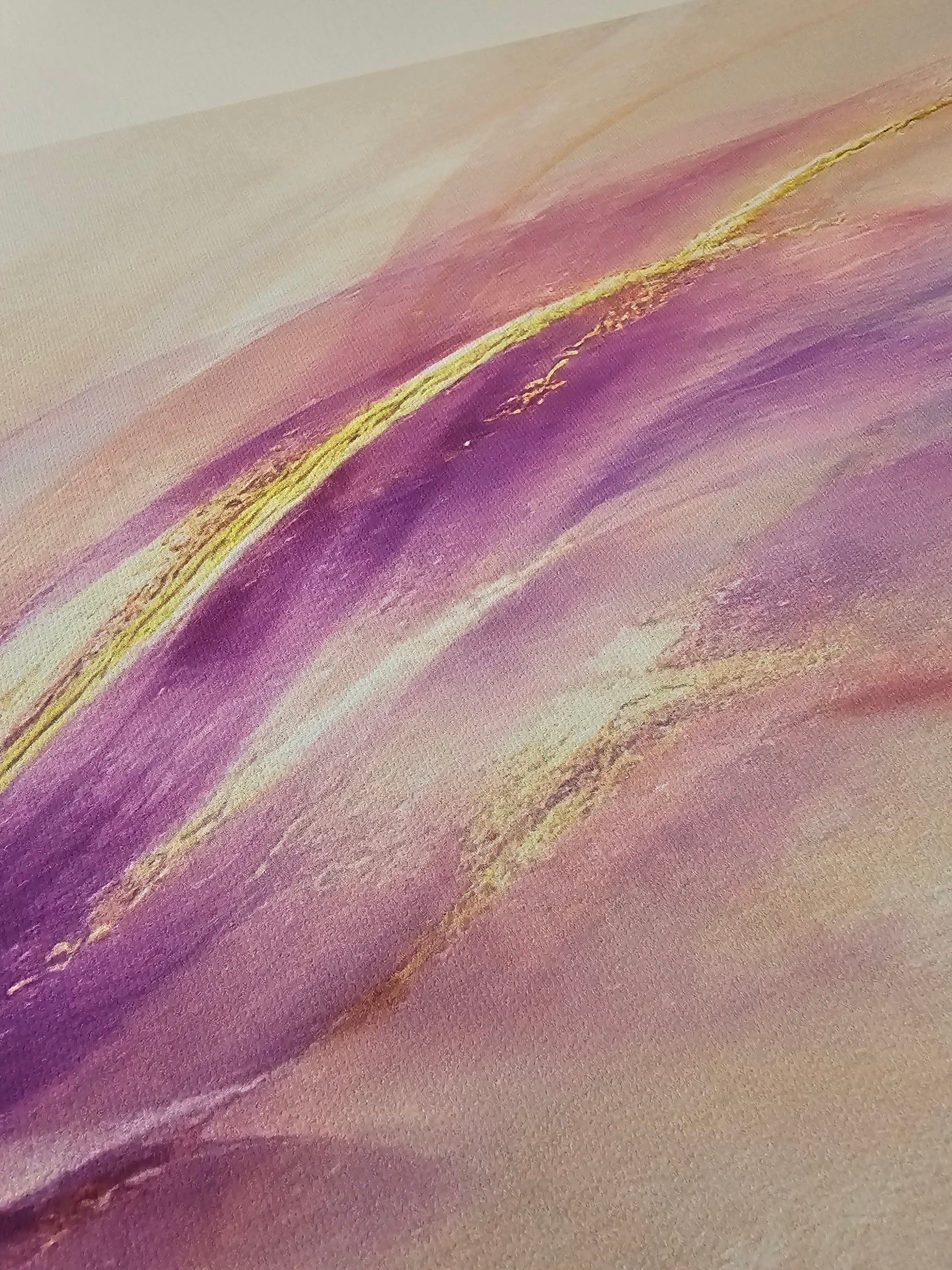 Abstract art with purple and gold colors on a textured surface