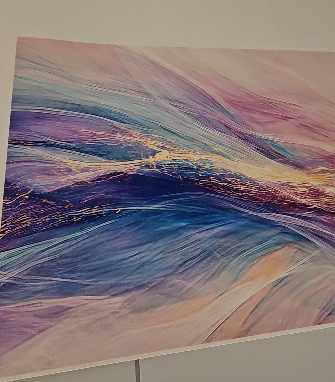 Abstract painting with wavy lines in purple, blue, and pink on a white wall.