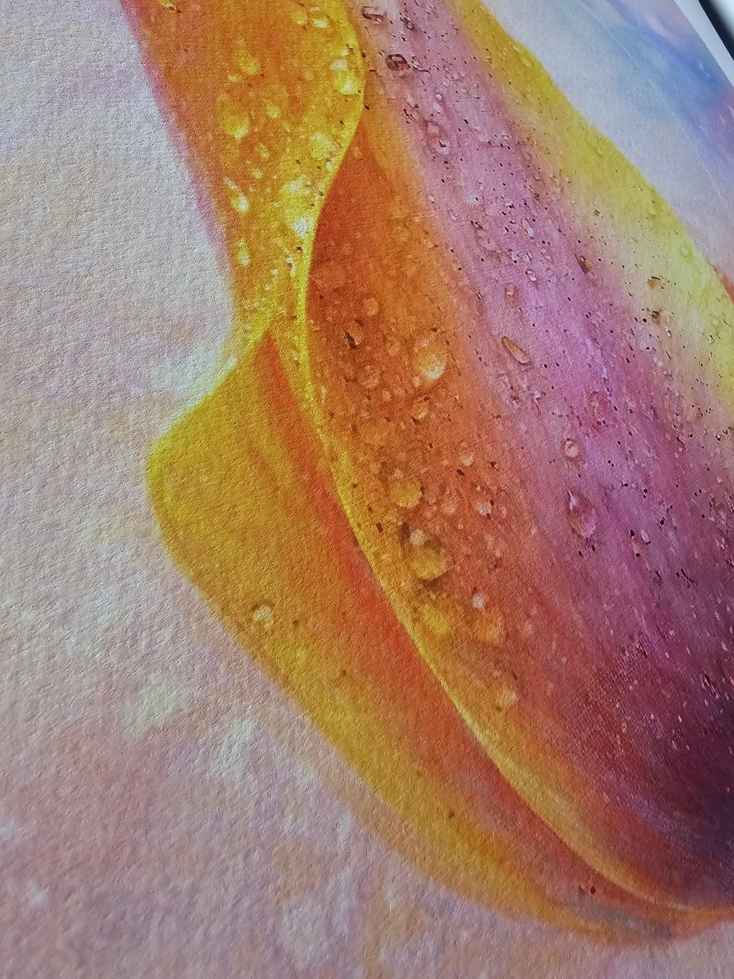 Close-up of a colorful abstract painting with vibrant hues on a textured surface.