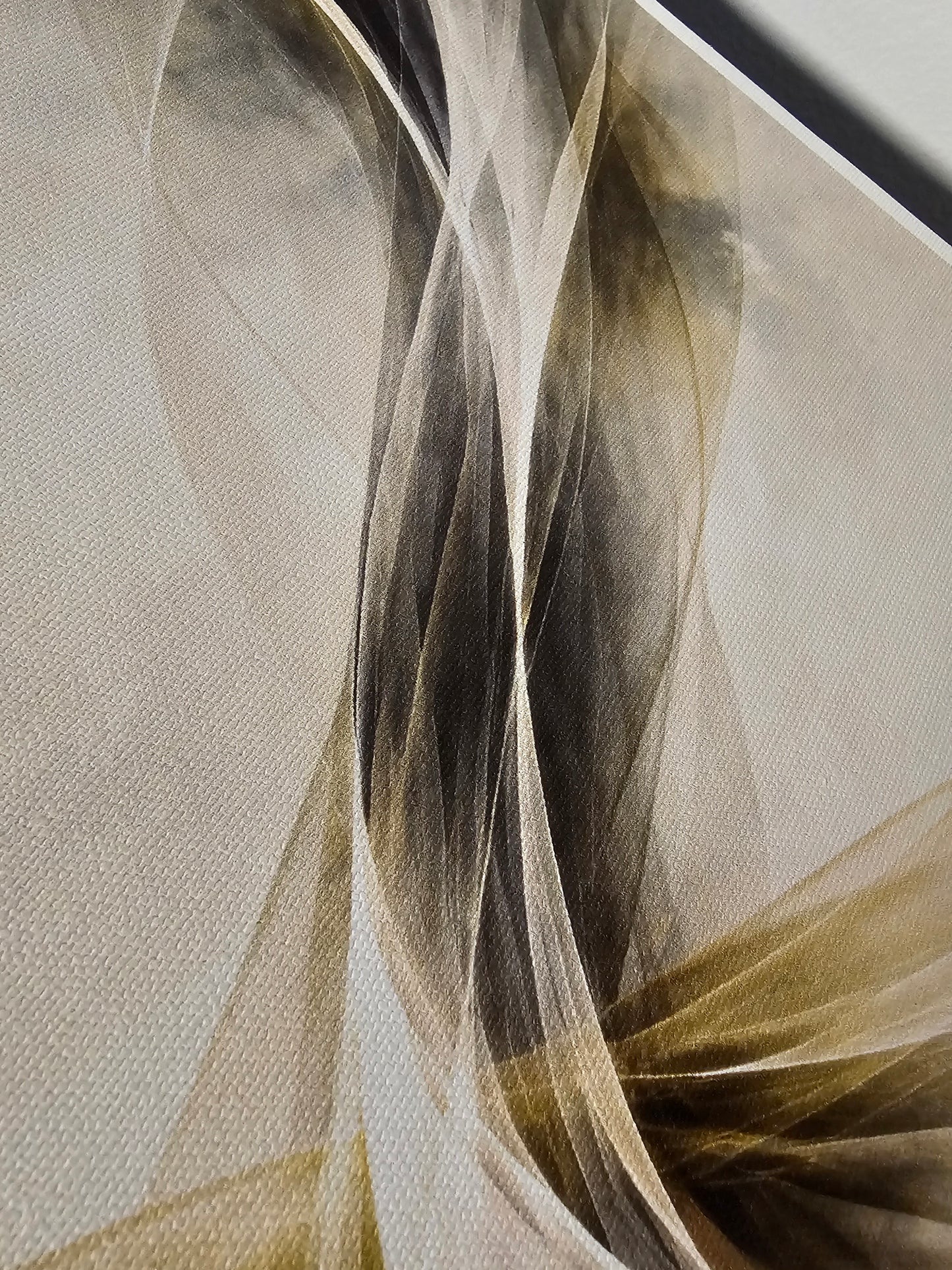Close-up of a textured fabric with wavy patterns in beige, brown, and gray.