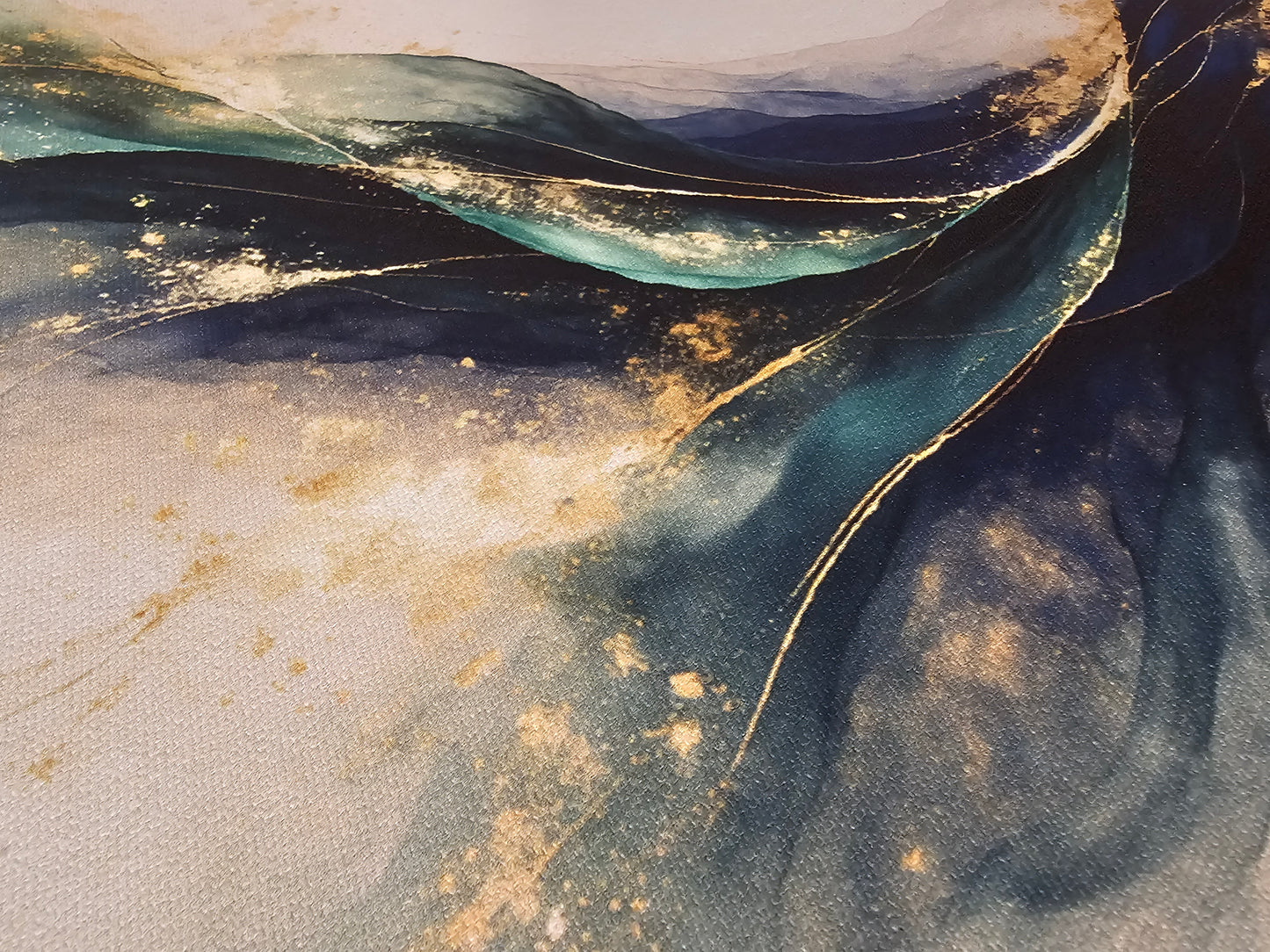 Abstract art with blue, gold, and beige colors on a textured surface
