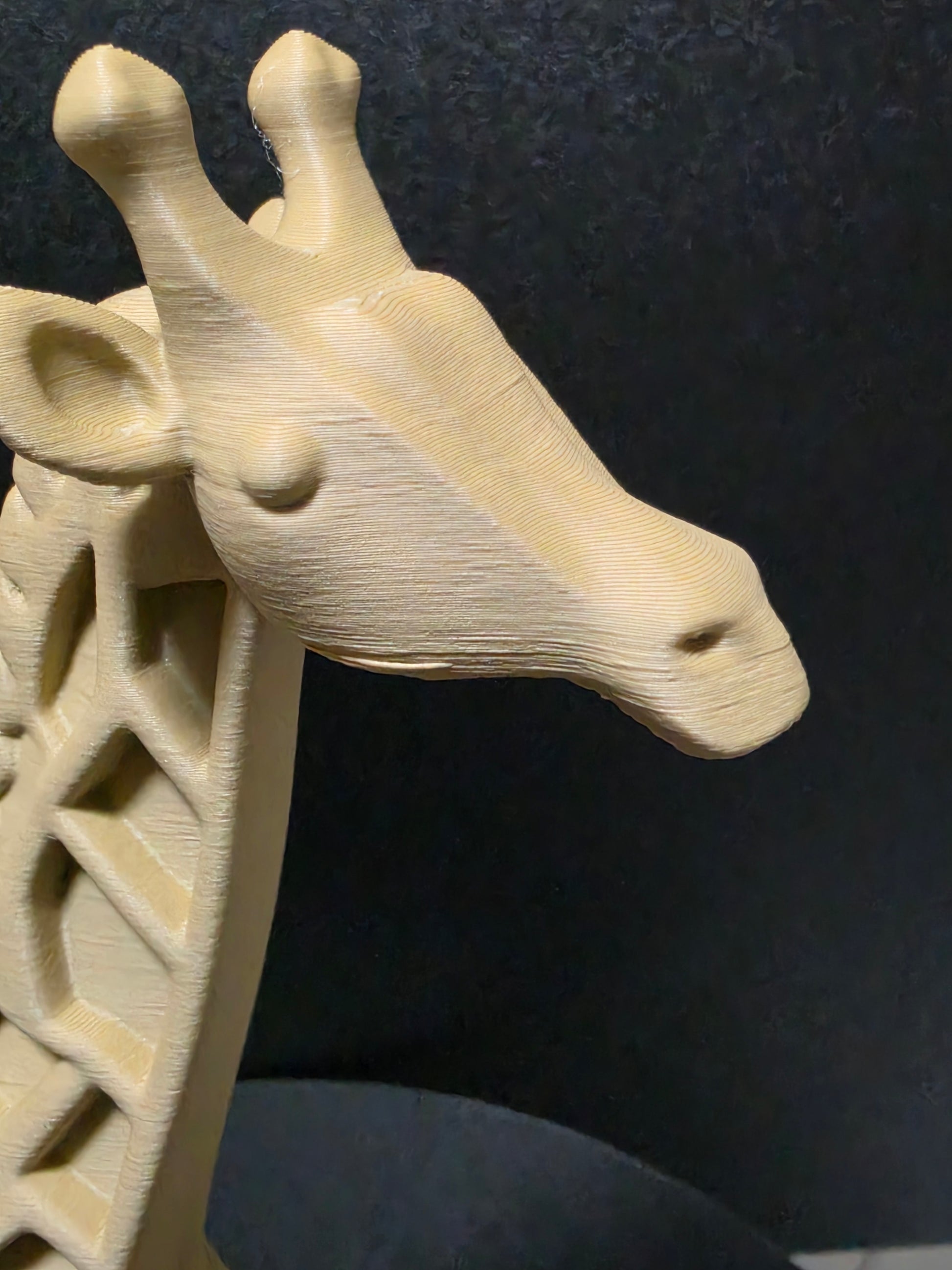 Wooden giraffe figure on a dark textured background