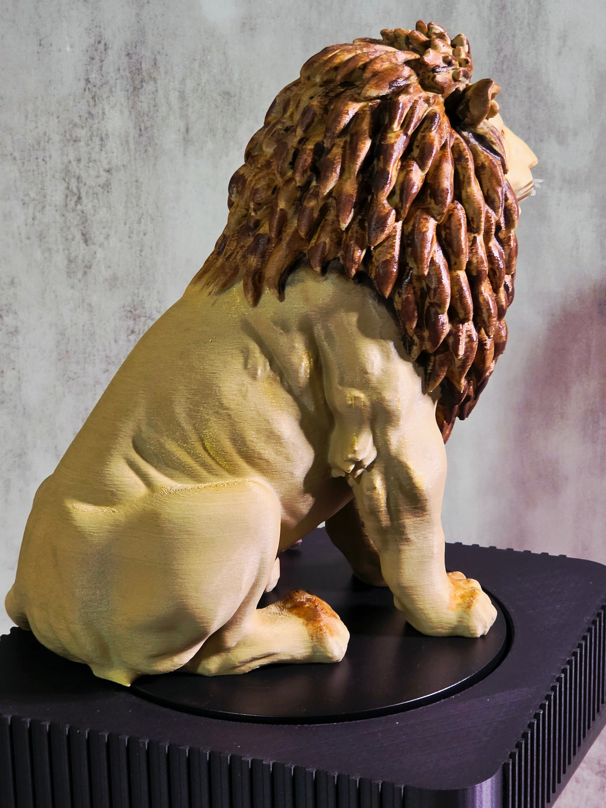 Seated Lion with a a painted main sculpture Side View