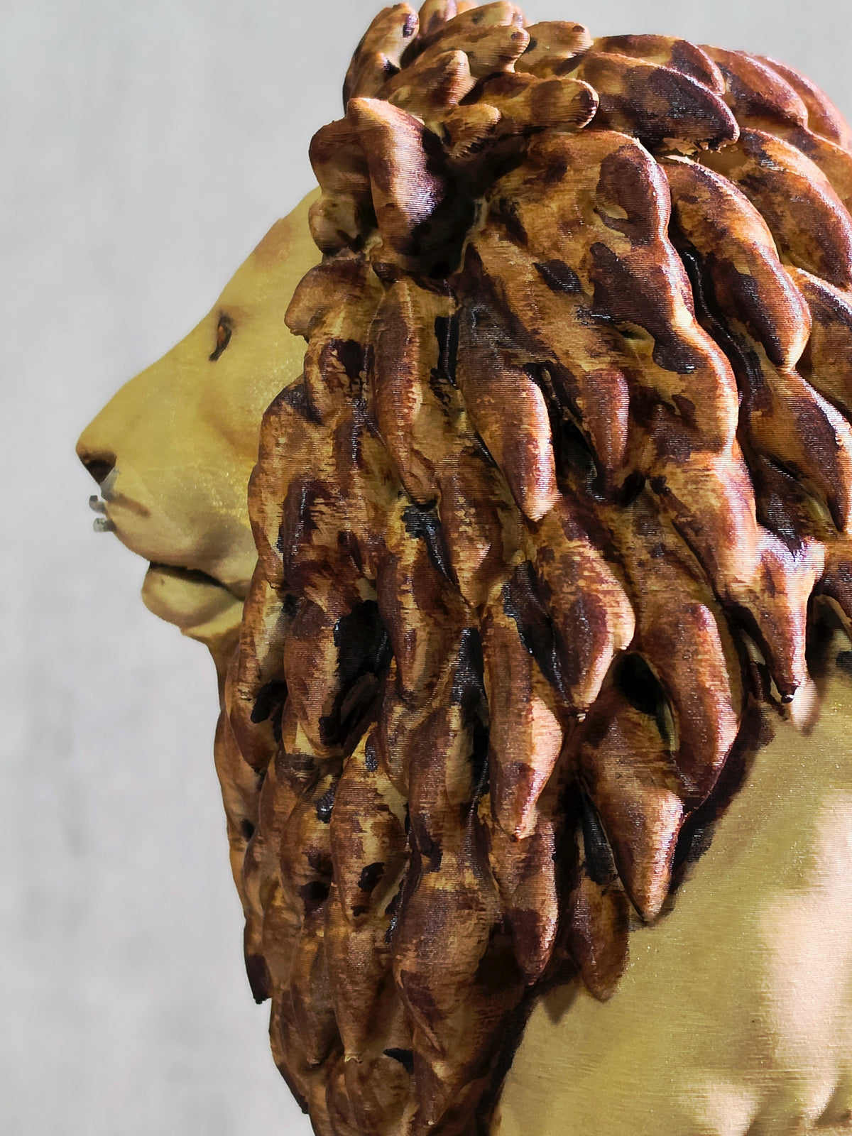 Seated Lion with a a painted main sculpture Side View