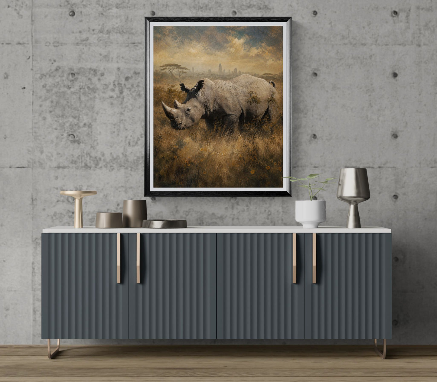Gray sideboard with decorative items against a gray wall with a framed landscape painting of rhinos.