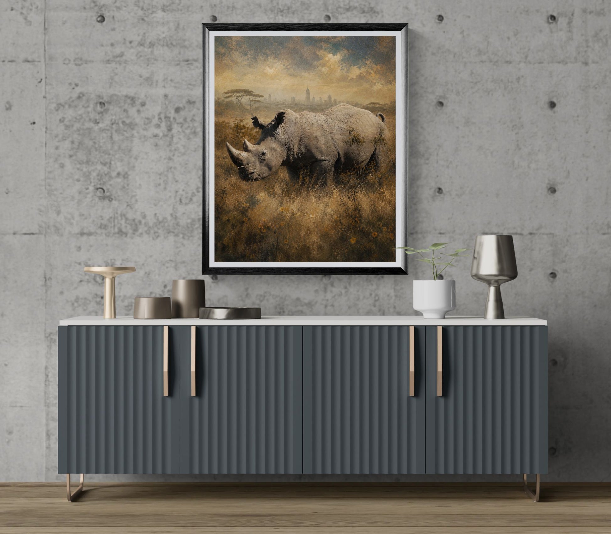 Gray sideboard with decorative items against a gray wall with a framed landscape painting of rhinos.