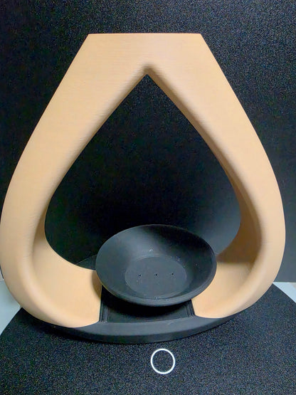 Beige and black vase with a tea candle/incense holder
