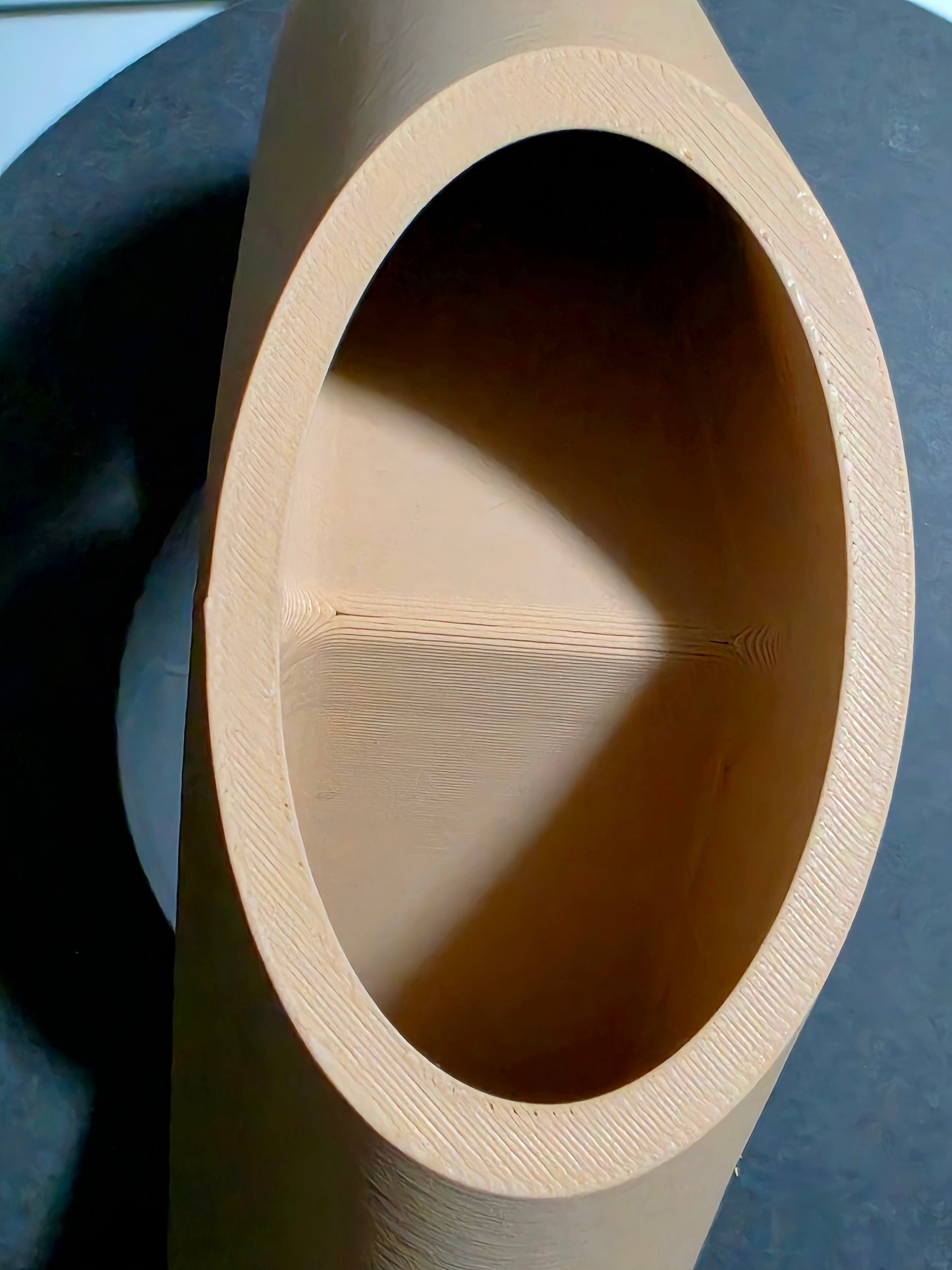Close-up of a sculpted vase with a dark background