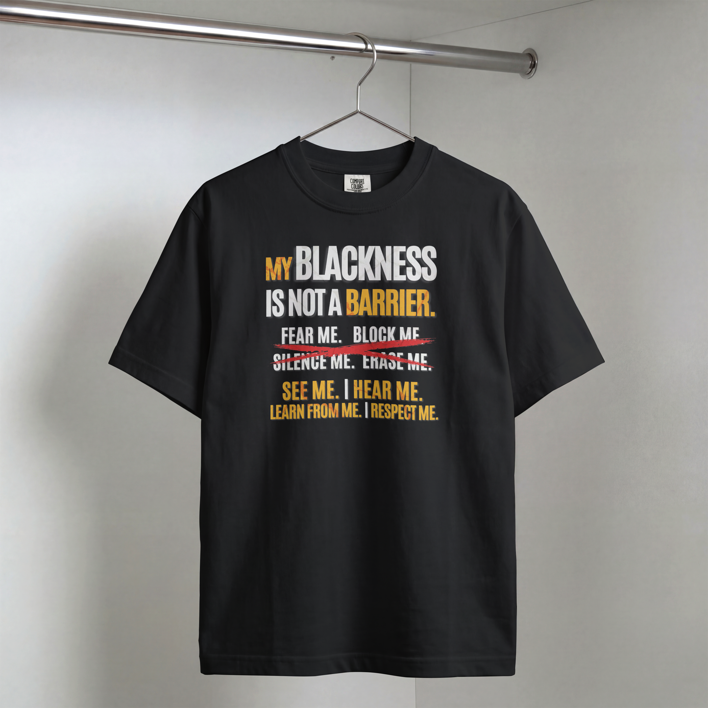 Black t-shirt with motivational message on a hanger against a plain background