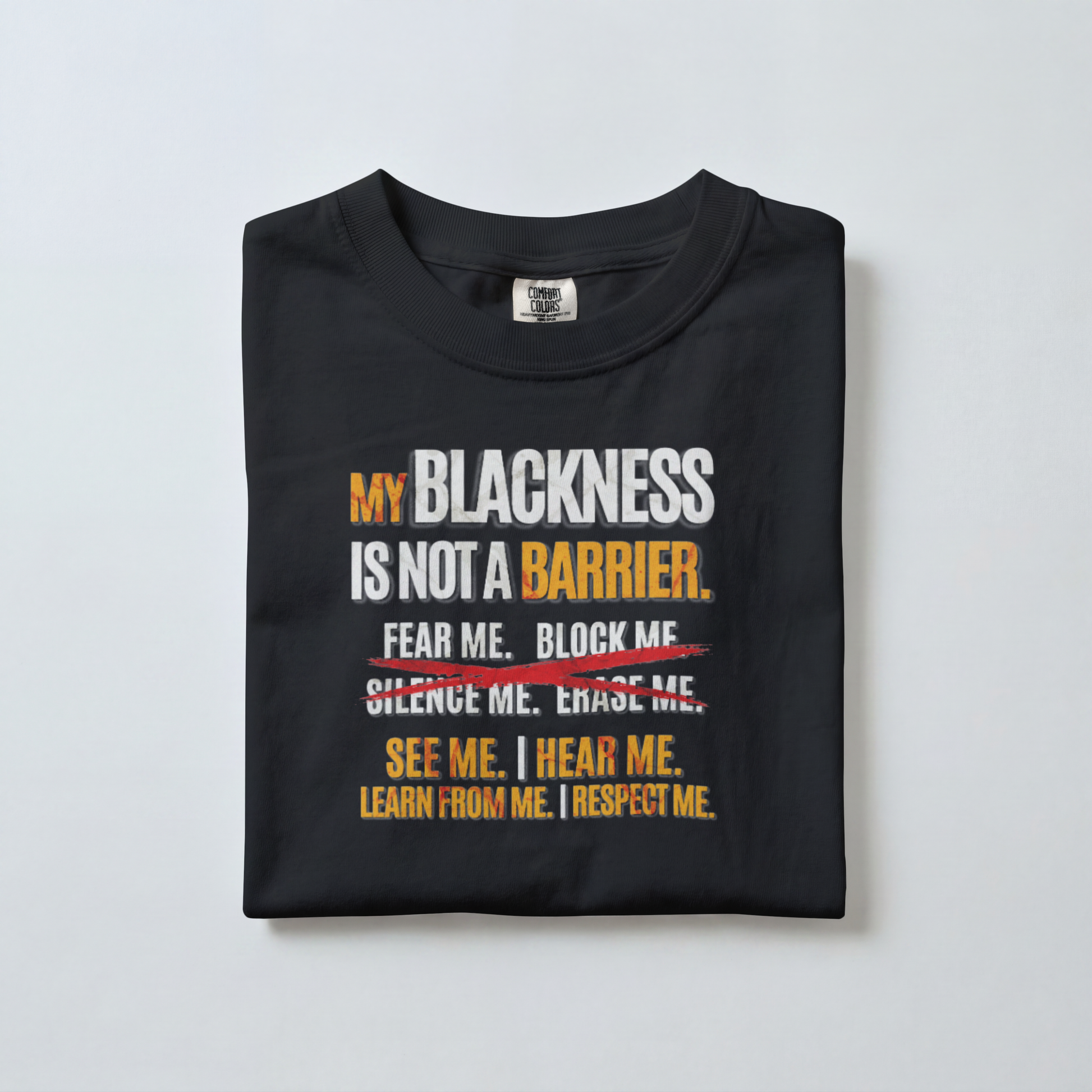 Folded black t-shirt with motivational message on a light gray background