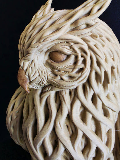 Close-up of a textured wooden sculpture owl on a black background