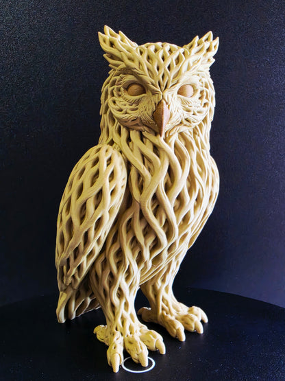 Decorative owl sculpture with intricate patterns on a dark background