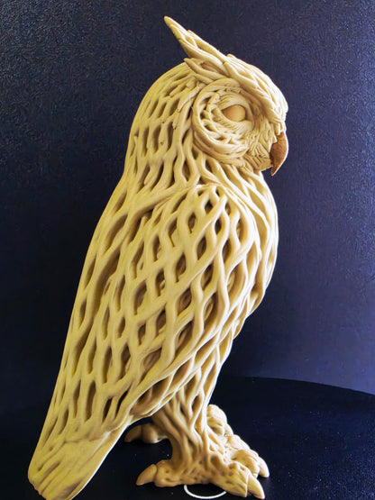 Wooden owl sculpture on a dark background