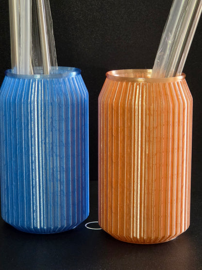 Two cylindrical objects, one gold and one blue, on a black background