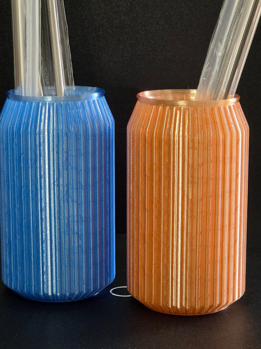 Two cylindrical objects, one gold and one blue, on a black background