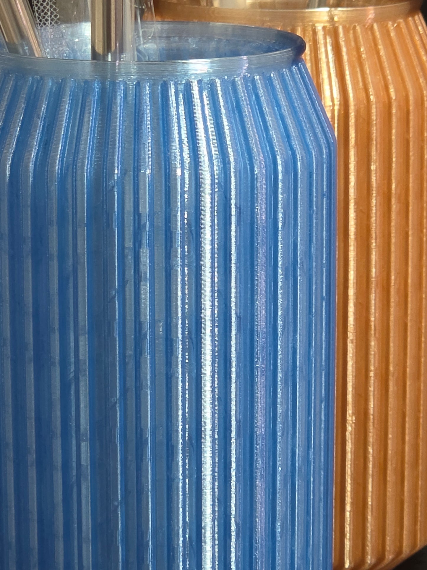 Close-up of a blue metal gear meshing with a gold metal gear.