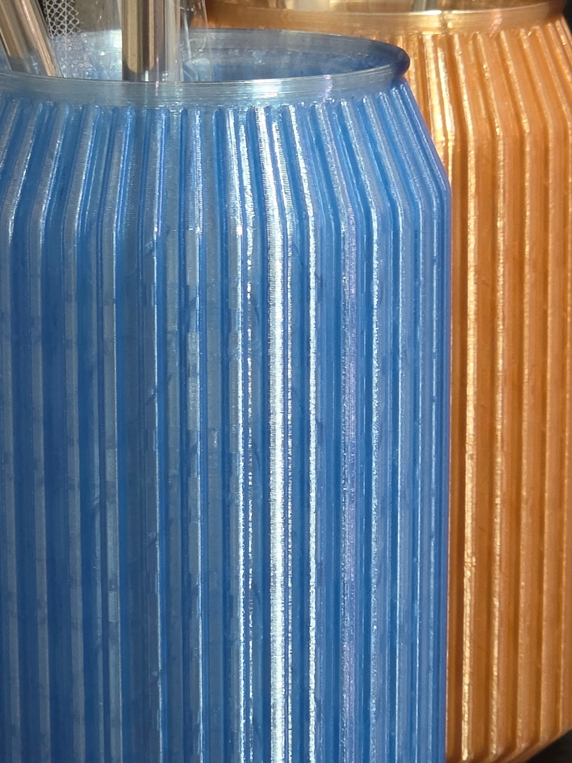 Close-up of a blue metal gear meshing with a gold metal gear.
