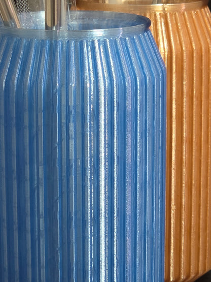 Close-up of a blue metal gear meshing with a gold metal gear.