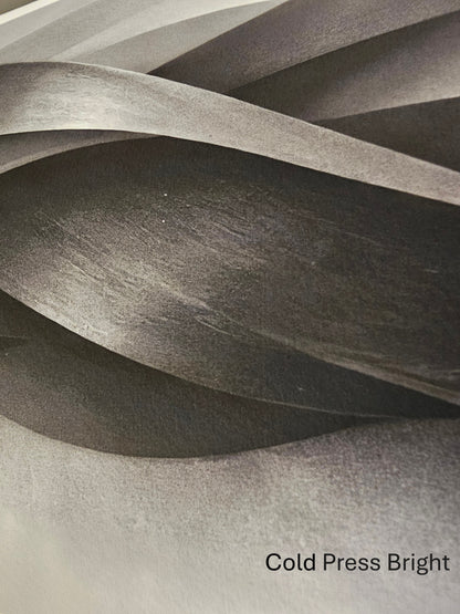 Textured paper with wavy layers and 'Cold Press Bright' label