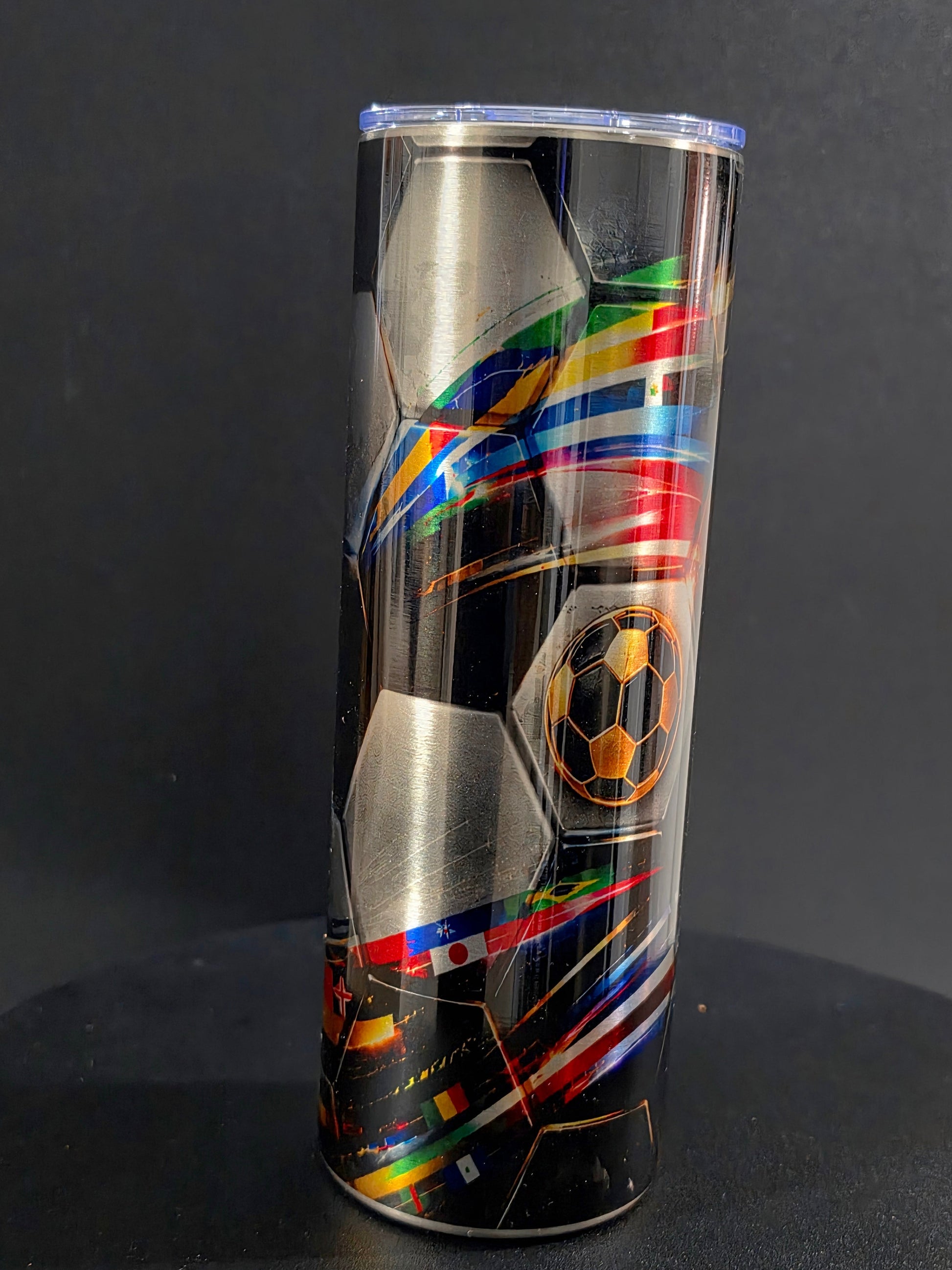 Soccer-themed tumbler with colorful design on a black background