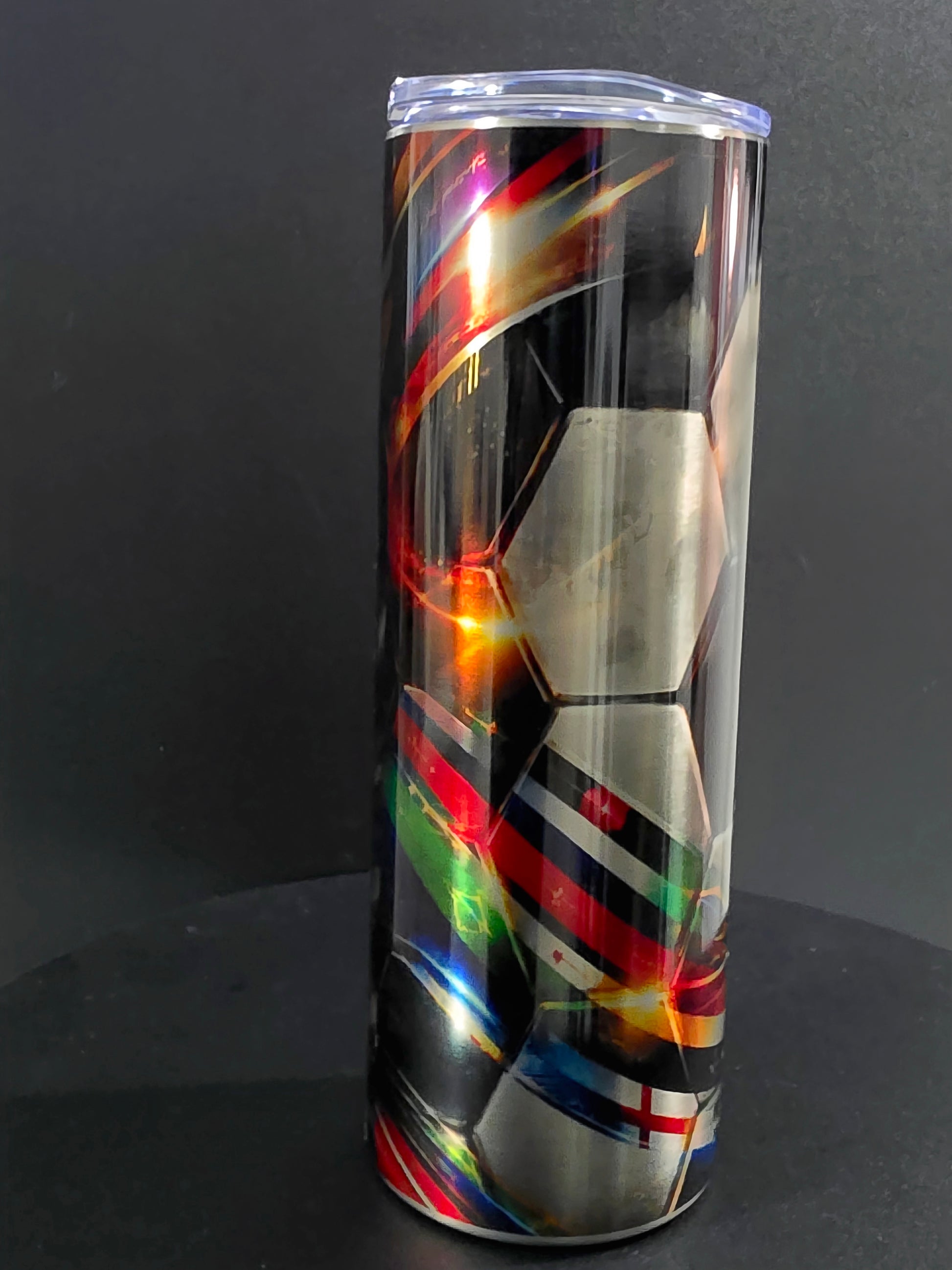 Colorful abstract design on a transparent cylindrical object against a dark background
