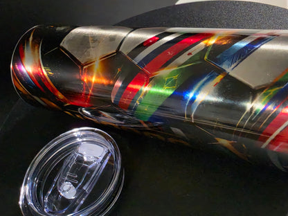 Multicolored tumbler with a clear lid on a dark surface