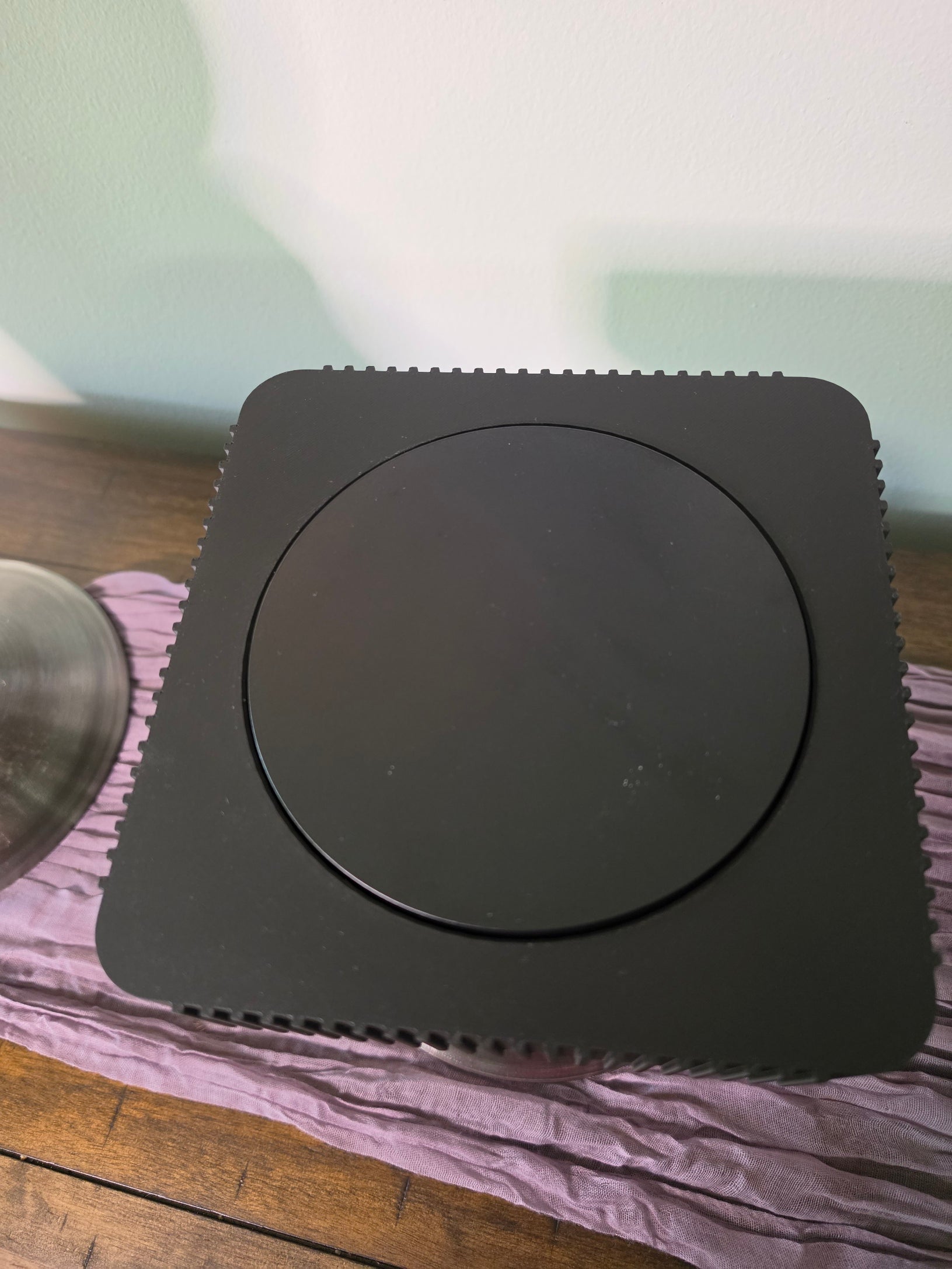 Square Rotating Art displays on pedestal