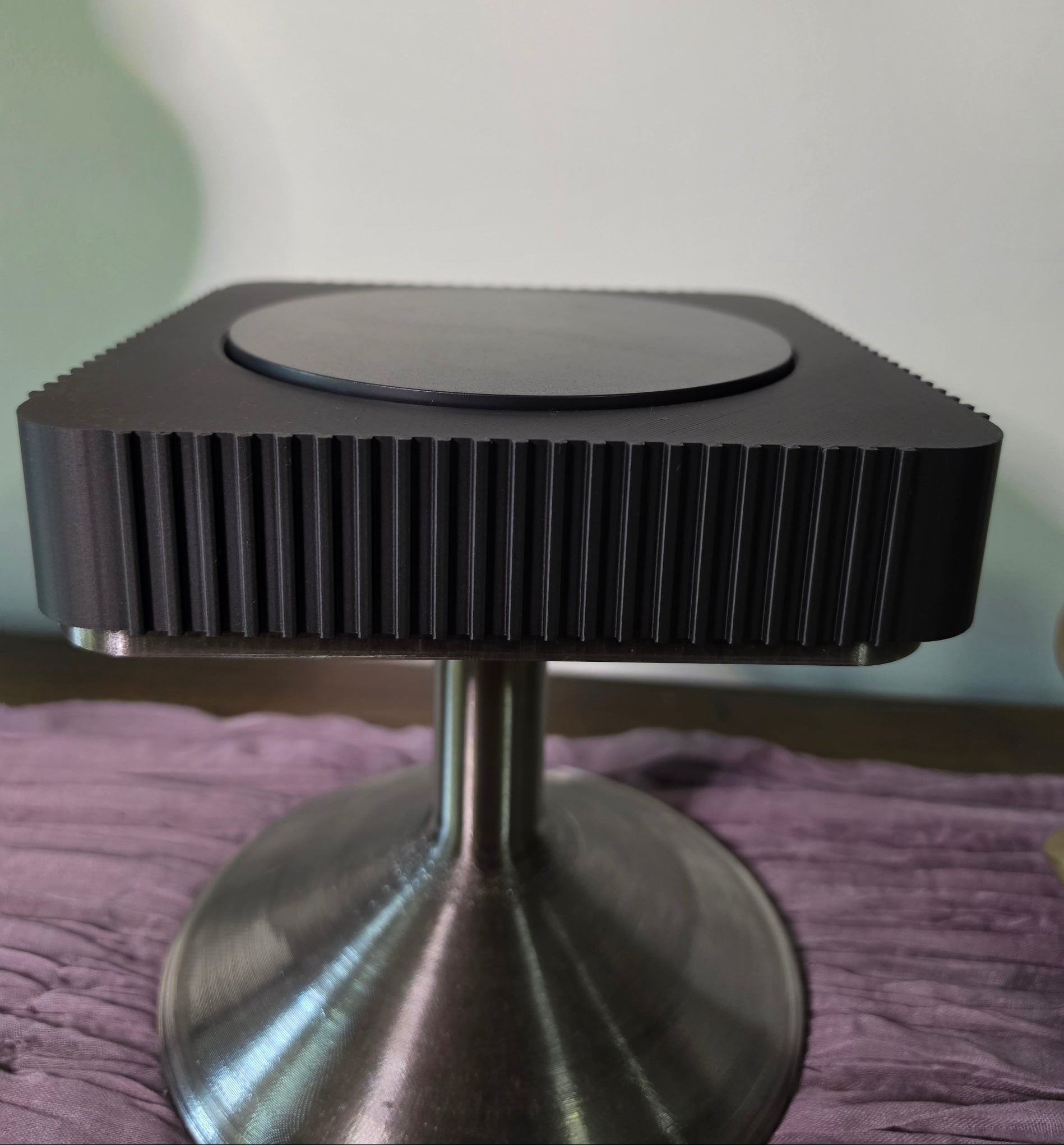Square Rotating Art displays on pedestal
