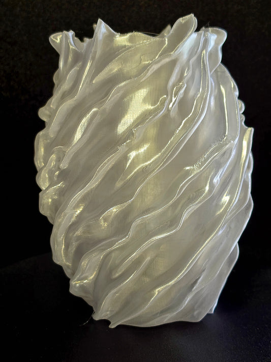 sculpture vase with wavy, layered design on a black background