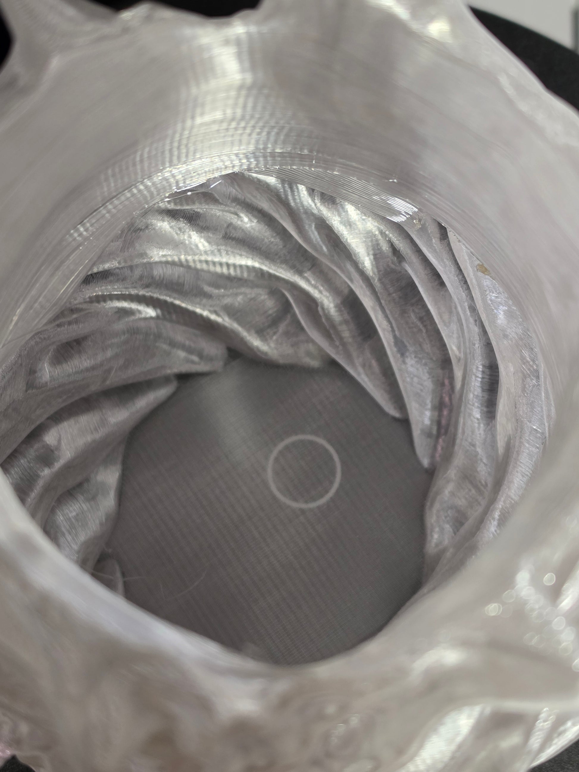 Close-up of the inside of a clear sculptural vase.