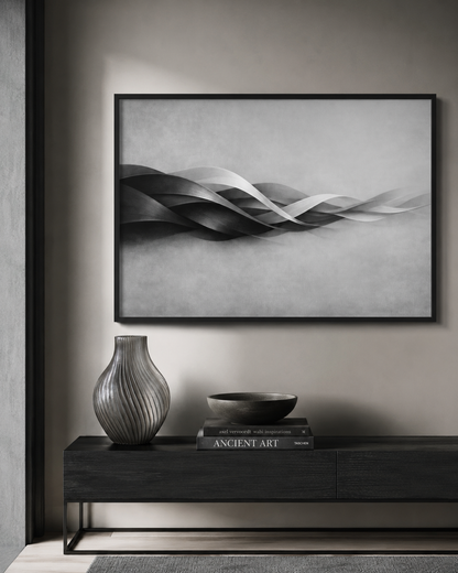Framed abstract art piece on a wall above a console table with decorative items.