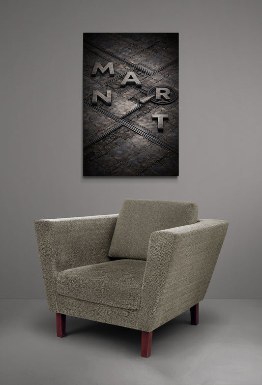 Beige armchair in a room with a dark abstract painting on the wall.