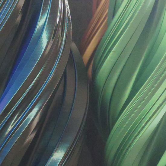 Apex Vases in Bronze, Green, Silver, and Black spinning on turntable display