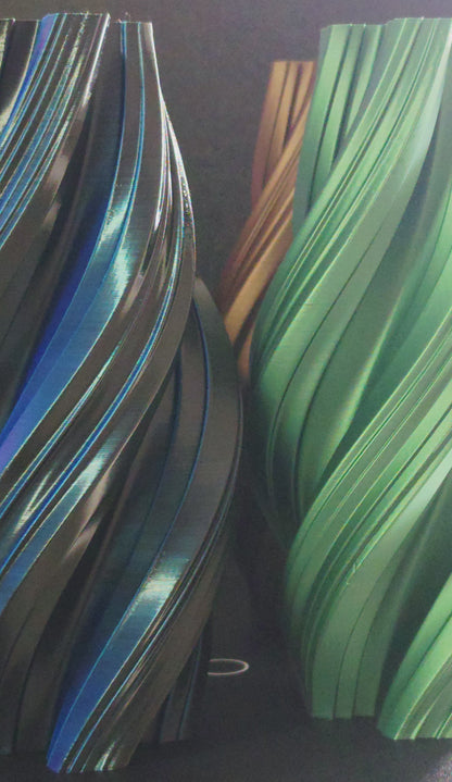 Apex Vases in Bronze, Green, Silver, and Black spinning on turntable display