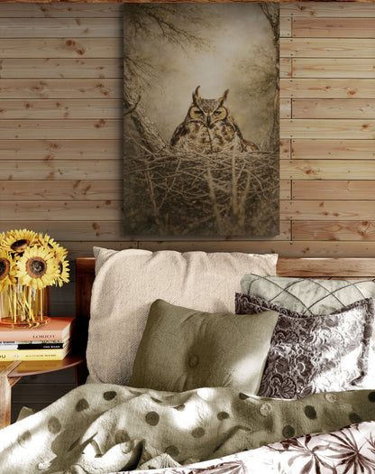 Bedroom with owl artwork on the wall, pillows, and sunflowers on a side table.