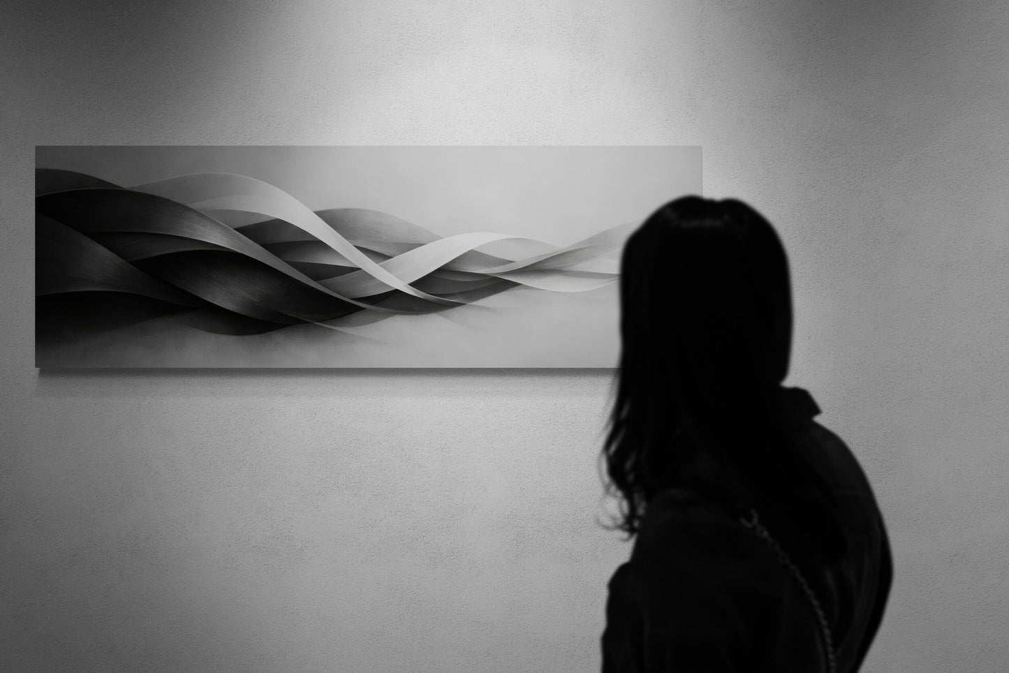 Person standing in front of a wall with a large abstract painting