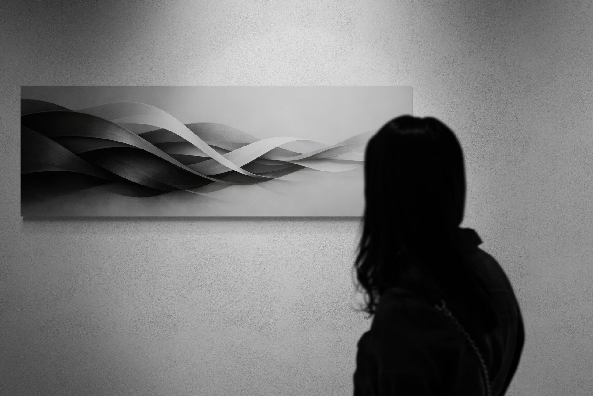 Person standing in front of a wall with a large abstract painting